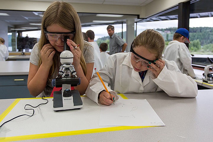 &lt;p&gt;From left, Emily Hart and Roxie Sandberg look into a microscope to observe different forms of zooplankton and algae pulled from the water in Lake Coeur d'Alene on Tuesday as part of a group of students from Hayden Meadows Elementary School visiting the University of Idaho Coeur d&#146;Alene Harbor Center Campus&lt;/p&gt;