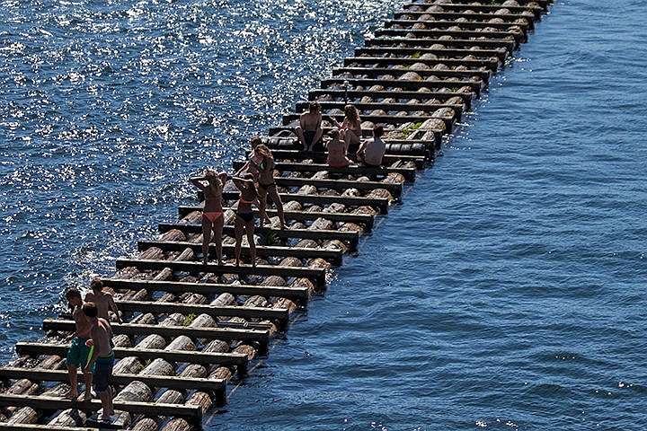 &lt;p&gt;Teenagers sit on the breakwater in the bay outside of the Coeur d'Alene Resort on Monday afternoon.&lt;/p&gt;