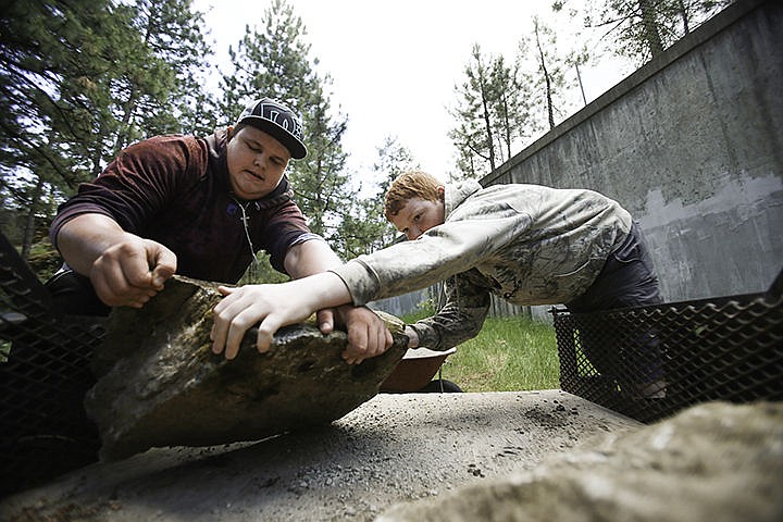 &lt;p&gt;New Vision High School freshman students Brandon Worfolk, left and Dylan Germano transfer rocks off a trailer to create steps for a path around the Treaty Rock Park. The school took part in the park improvement as a way to incorporate community involvement.&lt;/p&gt;