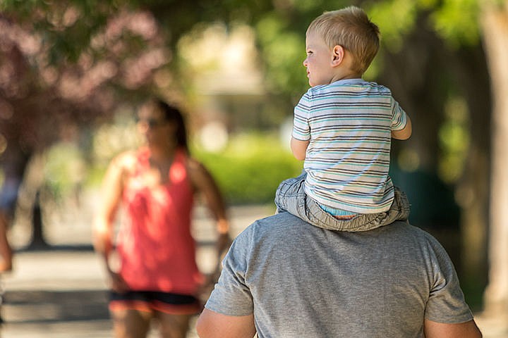&lt;p&gt;Josh Caldwell holds his two year old son Trevin on his shoulders while walking through Coeur d'Alene City Park on Tuesday morning.&lt;/p&gt;