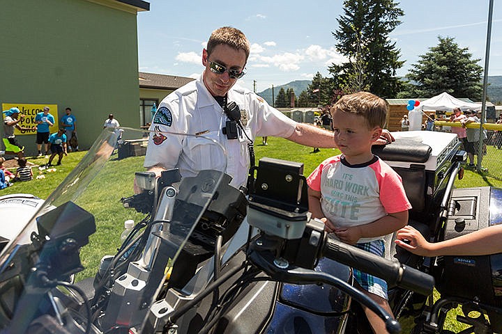 &lt;p&gt;Officer Aaron Ogle reeves the engine of his police motorcycle for three-year-old Sam Diteri at the Boys and Girls Club in Post Falls.&lt;/p&gt;
