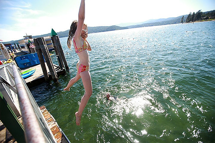 &lt;p&gt;Keeping cool on the exceptionally warm Tuesday, Aalia Greer, 13, gains the courage to catch some air off a dock at Independence Point in Coeur d&#146;Alene. Temperatures are expecting to cool off into the week.&lt;/p&gt;