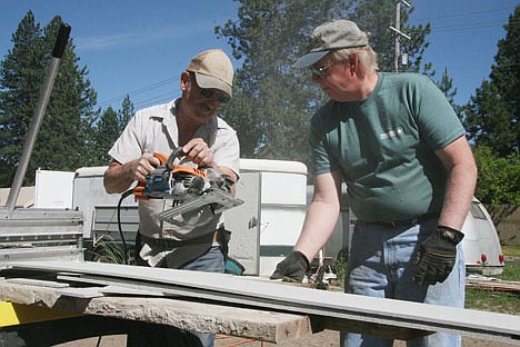 &lt;p&gt;Habitat for Humanity of North Idaho volunteers Tom Collier, left, and Ken Sande saw through a board on Saturday at the Habitat home on 12th and Hazel. About 20 workers continued work on a new home for Kathy French of Coeur d'Alene.&lt;/p&gt;