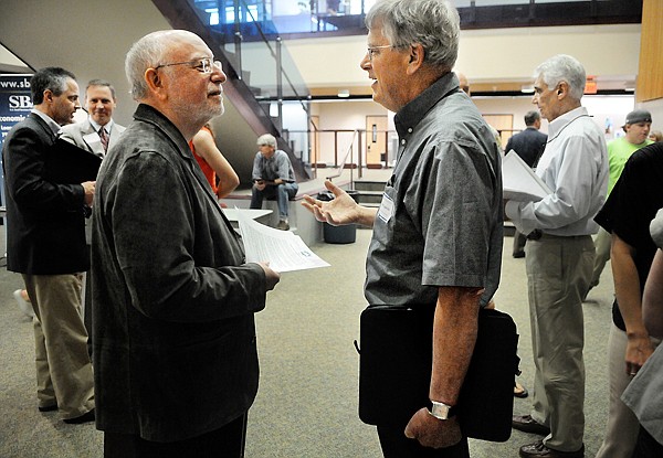 Chairman of Fifth Wave Leadership Morrie Shechtman, left, speaks with John Zupicich of Bigfork on Friday at the Small Business Opportunity Workshop at FVCC.