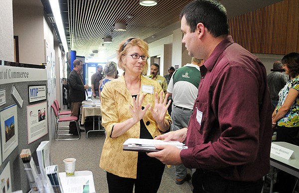 Trudy Skari with the Department of Commerice, center, speaks with Braden Pitman of Missoula on Friday at the Small Business Opportunity Workshop at FVCC. Pitman works for Abatement Contractors of Montana.