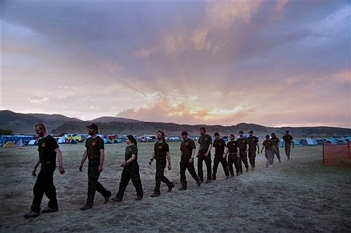 &lt;p&gt;In this June 19, 2012, photo provided by the Colorado Army National Guard, firefighters from Coeur D'alene, Idaho march to dinner at sunset in the base camp for the High Park wildfire in Fort Collins, Colo. Thousands of wildland firefighters aren&#146;t eligible for federal health insurance so they have launched an online petition to change that_ drawing more than 90,000 signatures in a matter of days. (AP Photo/Colorado Army National Guard, John Rohrer)&lt;/p&gt;