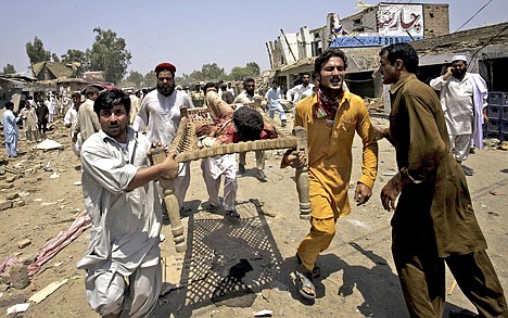 &lt;p&gt;People carry an injured person from the spot of bombing in Yakaghund in Pakistani tribal area of Mohmand on Friday, July 9, 2010. A suicide bomber on a motorcycle struck outside a government office Friday in the region where Pakistan's army has fought the Taliban, killing scores of people and left many injured, officials said.&lt;/p&gt;