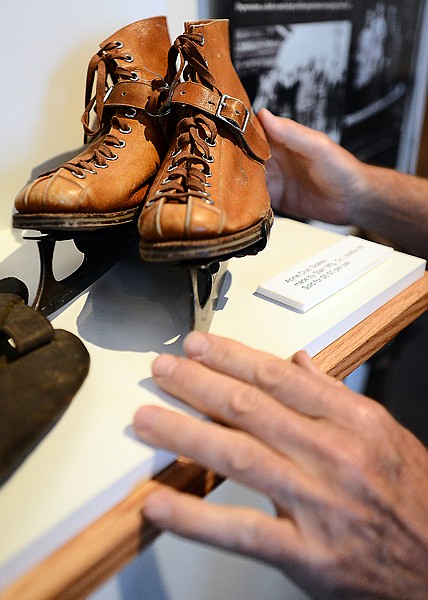 <p>Gil Jordan arranges items in a display case as he finishes up preparing for the opening of the "History of the Flathead Valley" exhibition at the Museum at Central School. (Brenda Ahearn/Daily Inter Lake)</p>