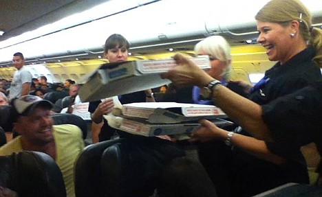 &lt;p&gt;A Frontier Airlines flight attendant passes out pizza to passengers aboard a Denver-bound flight diverted to Cheyenne, Wyo. The airplane pilot treated his passengers to the pizza after they were diverted.&lt;/p&gt;