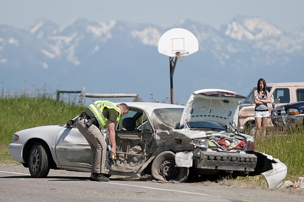 &lt;p&gt;A bystander watches as a Montana highway patrolman marks the
final resting place of a vehicle that was struck by an oncoming
truck on U.S. 2 west of Kalispell Wednesday afternoon.&lt;/p&gt;