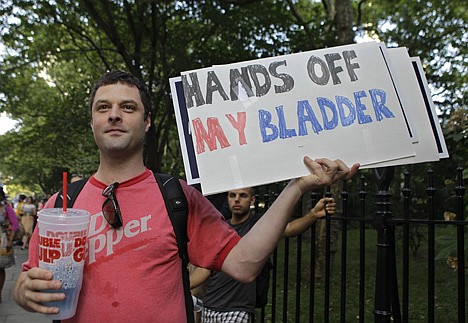 &lt;p&gt;Dominic Inferrera holds a homemade sign during a protest in opposition to Mayor Michael Bloomberg's proposal to prohibit licensed food establishments from using containers larger than 16 ounces to serve high-calorie drinks at City Hall in New York, Monday, July 9, 2012. in New York, Monday, July 9, 2012. (AP Photo/Kathy Willens)&lt;/p&gt;