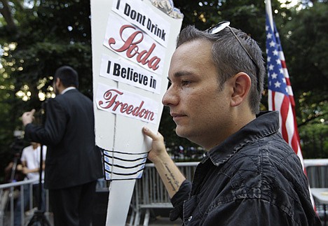 &lt;p&gt;Danny Panzella protests during a &quot;Million Gulp&quot; demonstration against Mayor Michael Bloomberg's proposal to prohibit licensed food establishments from using containers larger than 16 ounces to serve high-calorie drinks like colas at City Hall in New York, Monday, July 9, 2012. in New York, Monday, July 9, 2012. (AP Photo/Kathy Willens)&lt;/p&gt;