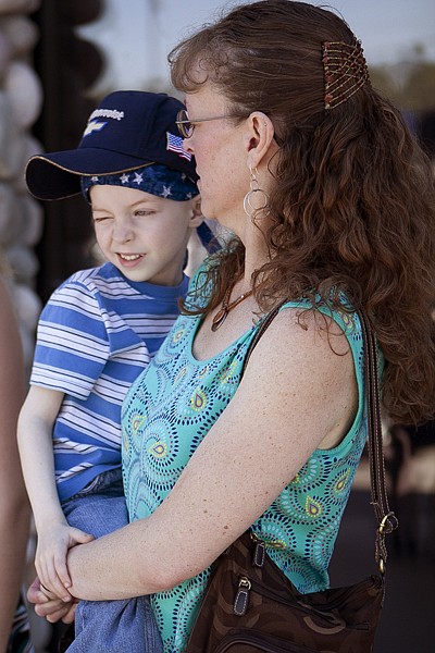 &lt;p&gt;Hunter Brown, 5, is held by his mother Katie as they wait to be
presented their new 2006 Dodge Caravan at Don K Chevrolet in
Whitefish Thursday afternoon.&lt;/p&gt;