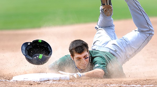 Mission Valley&#146;s Xavier Morigeau sends dust and his helmet flying as he slides safely into third base for a triple during the fourth inning against Anacortes, Wash., on Saturday in Kalispell at the John R. Harp Tournament.