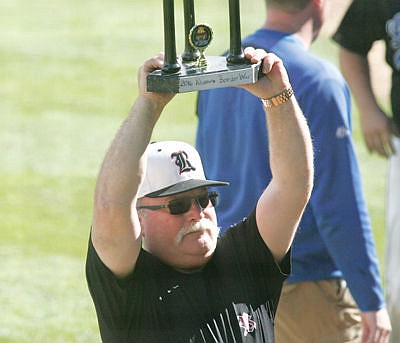 &lt;p&gt;Strathmore Reds alumni coach Darwin Armitage displays the 2016 alumni border war trophy after the Reds swept the Logger Legends in Saturday's doubleheader alumni game.&lt;/p&gt;