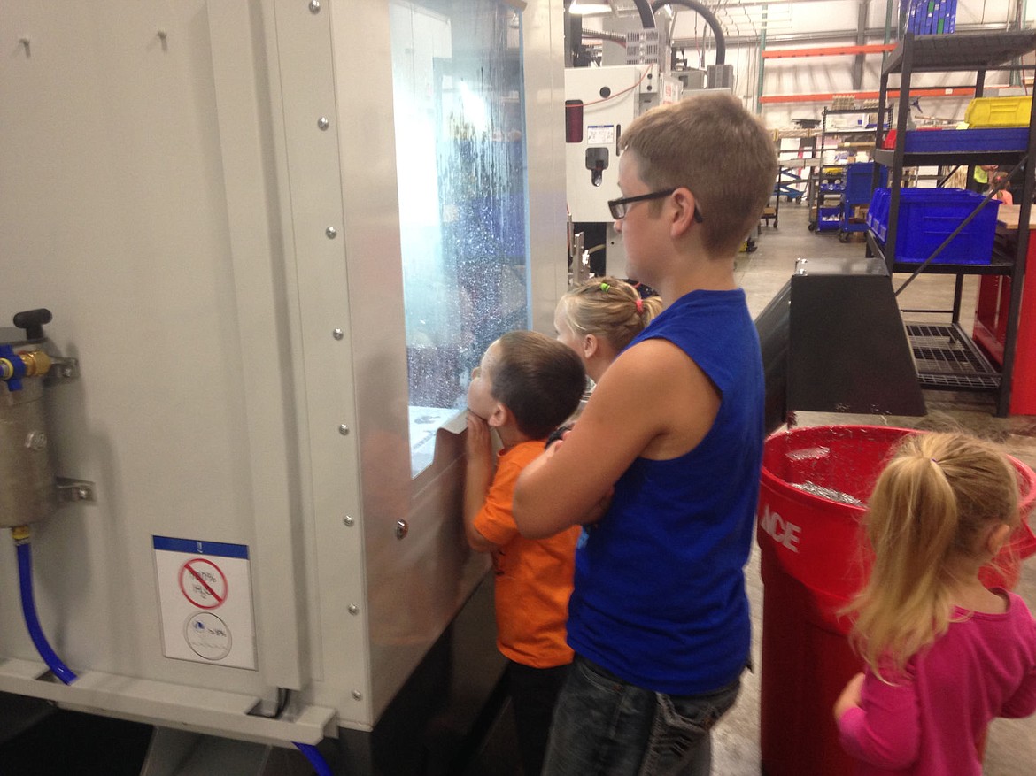 &lt;p&gt;Matthew Sweet (blue shirt) watches a fabrication cleaning machine with Rhet (orange shirt) and Callie Donnelly (pink shirt). (Bethany Rolfson/The Western News)&lt;/p&gt;