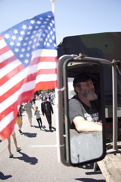 <p>Brian Nehall from Swan Lake waits for the Bigfork 4th of July parade to begin on Wednesday. Nehall says his wife talked him into driving his camouflaged 1972 American truck in the parade this year.</p>