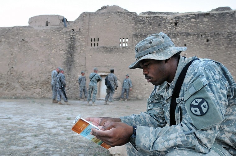 A chaplain&#146;s assistant reads at right while soldiers tour St. Elijah&#146;s Monastery.