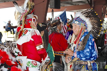 &lt;p&gt;Frances Stanger walks down the line of dancers, greeting each one with a handshake during the grand entry Friday afternoon.&lt;/p&gt;