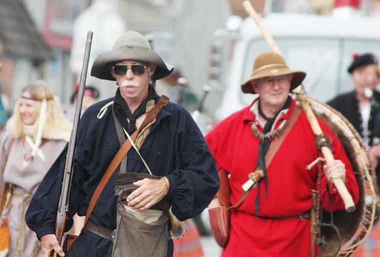 Randy Burns, followed by Paul Fielder, donned traditional clothing for the Independence Day parade.