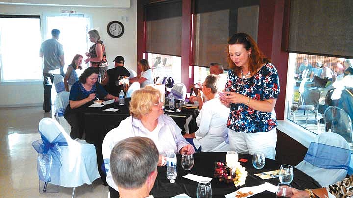 Guests at the first Taste of the Wahluke Slope enjoy wine samples and foods provided by local vendors.