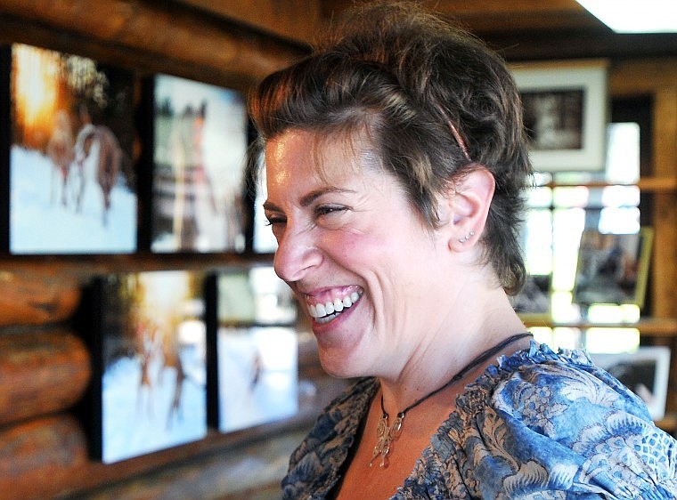 Lauren Grabelle smiles while interacting with a guest in her building space in Bigfork.