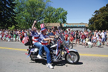 &lt;p&gt;A couple of bikers decked out in red, white and blue pause to wave to the crowd during the Polson Fourth of July parade.&lt;/p&gt;