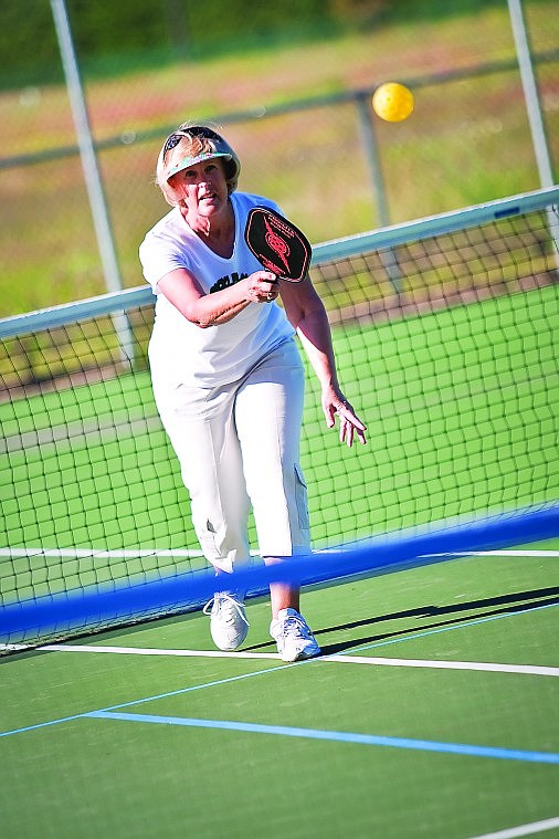 <p>Judy Thormahlen of Hayden sends a serve to her competitors Thursday evening on the tennis courts at Northshire Park.</p>