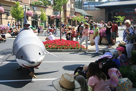 &lt;p&gt;Ross Welburn &#147;lunges&#148; his sharkmobile at joyful bystanders Sunday during the Kinetic Festival Parade. Welburn, a retired engineer, made the mobile shark to entertain kids and because &#147;it&#146;s just plain, good old-fashioned fun.&#148;&lt;/p&gt;