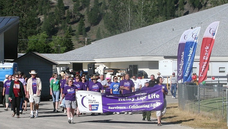 <p>Cancer survivors finish the first lap of the 2011 Mineral County
Relay for Life in Superior Friday afternoon.</p>