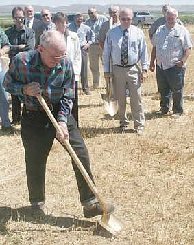 PHOTOS: 1. Albert Reiman shakes hands with Quincy Port commissioners Patric Connelly, Brian Kuest and Curt Morris after breaking ground at the site of the pending intermodal system Monday morning. Morris said Reiman was asked to dig the first shovelful of dirt because he's a lifelong Quincy resident and is a large train enthusiast.<br>2. Quincy Port commissioners Patric Connelly and Brian Kuest listen as Curt Morris talks to an audience of nearly 50 people Monday morning at the ground breaking ceremony for the intermodal system.<br>3. Albert Reiman presses a golden shovel into the ground at the site of the pending intermodal system during the ground breaking ceremony Monday morning. Quincy Port commissioner Curt Morris said Reiman was asked to dig the first shovelful of dirt because he's a lifelong Quincy resident and is a large train enthusiast.<br>4. Quincy Port commissioners Patric Connelly and Brian Kuest listen as Curt Morris talks to an audience of nearly 50 people Monday morning at the ground breaking ceremony for the intermodal system.<br>5. Quincy Port commissioners Patric Connelly, Brian Kuest and Curt Morris each press a golden shovel into the ground during the Monday morning ground breaking ceremony for the intermodal system.