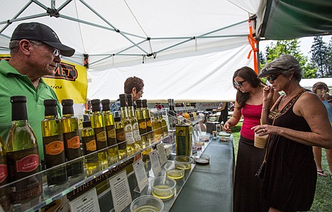 &lt;p&gt;Kay Schilling, right, and Brianne Morris of Post Falls sample olive oil and balsamic vinegar created by husband and wife Aurelio Munoz Jr. and Linda Gomez at their booth Three Rivers Gourmet on Saturday at the Post Falls Festival. Over 80 vendors will display their goods over the weekend.&lt;/p&gt;