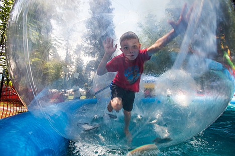 &lt;p&gt;Taelon Petrilla, 7, of Post Falls is surprised he can't find his footing inside an inflatable ball in a pool at the Post Falls Festival on Saturday in Q'emlin Park. Over 10,000 people are anticipated to attend the festival throughout the weekend.&lt;/p&gt;