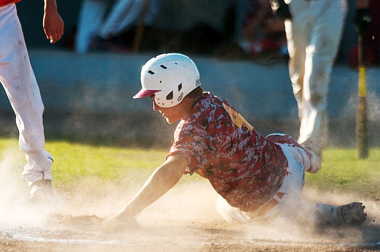 &lt;p&gt;Kalispell's Quinn Barber slides in safe to home plate Saturday evening during the Lakers game against Vauxhall in the John R. Harp tournament at Griffin Field in Kalispell. (Patrick Cote/Daily Inter Lake)&lt;/p&gt;