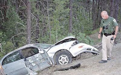 &lt;p&gt;MHP-164 Bryce Ford studies the accident scene Tuesday evening which occurred at the 16.2 mile marker, State Hwy. 37, one mile south of Libby Dam.&lt;/p&gt;