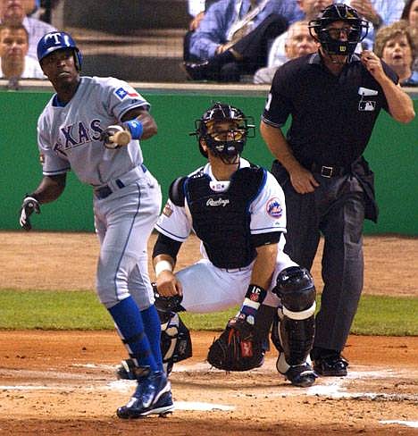 American League's Alfonso Soriano of the Texas Rangers watches the flight of his three-run home run as National League catcher Mike Piazza of the New York Mets and umpire Ed Montague watch during the first inning of the 75th All-Star Game Tuesday, July 13, 2004, in Houston. (AP Photo/Tony Gutierrez)