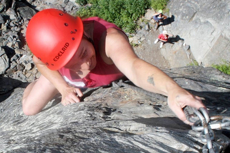 Faye Couture of Plains climbs up a rock face at Camp Bighorn on Saturday as part of the Women in the Outdoors Workshop.
