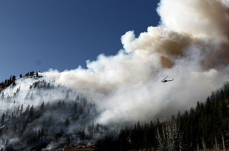 <p>A Forest Service Single Engine Air Tanker (SEAT) prepares to dump water on a 20-50 acre wildfire just west of Superior Sunday evening. </p>