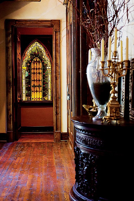 <p>SHAWN GUST/Press A leaded glass window, purchased from a local antiques dealer, provides a bit of color to one of the washrooms near the front entrance of the home.</p>