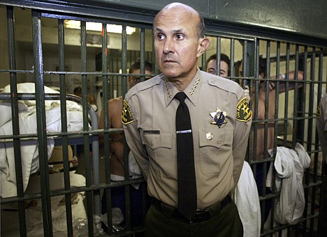 &lt;p&gt;FILE - This May 19, 2004 file photo shows Los Angeles County Sheriff Lee Baca during a tour of the Men's Central Jail in Los Angeles. The Los Angeles County Sheriff's Department has been accused of hiding details of deputy assaults on inmates, but also has had to scrap a questionable program where official-looking badges were given to local civic leaders. (AP Photo/Damian Dovarganes, File)&lt;/p&gt;