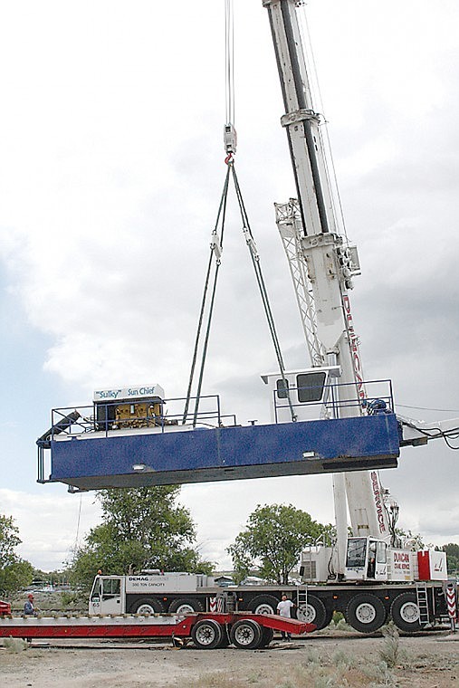 The Moses Lake Irrigation &amp; Rehabilition District's dredge
is lowered into Moses Lake in June.