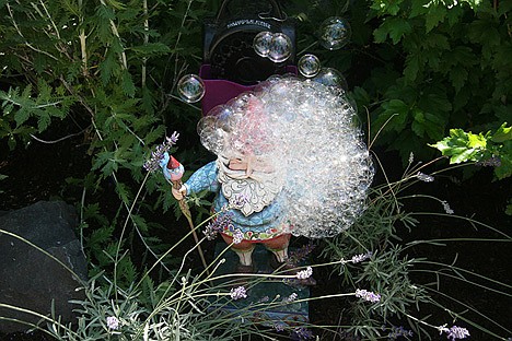 &lt;p&gt;A bubble machine covers a gnome with bubbles, causing several Garden Tour guests to laugh and take a picture in Jean Kinda's garden Sunday.&lt;/p&gt;