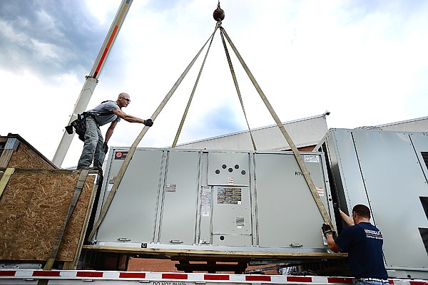 &lt;p&gt;T.J. Archer, left, and crew foreman Johnny Sims of Carson Brothers prepare to install a new heating, venting and air conditioning system at Flathead High School Thursday morning. More than $2.5 million in energy-saving projects are being completed at the school, $1.2 million of which is paid for by a Quality Schools grant. Kalispell Public Schools also recently received $2.2 million in zero-interest Qualified Zone Academy Bond loans, which will be repaid over a 15-year period using energy savings.&lt;/p&gt;