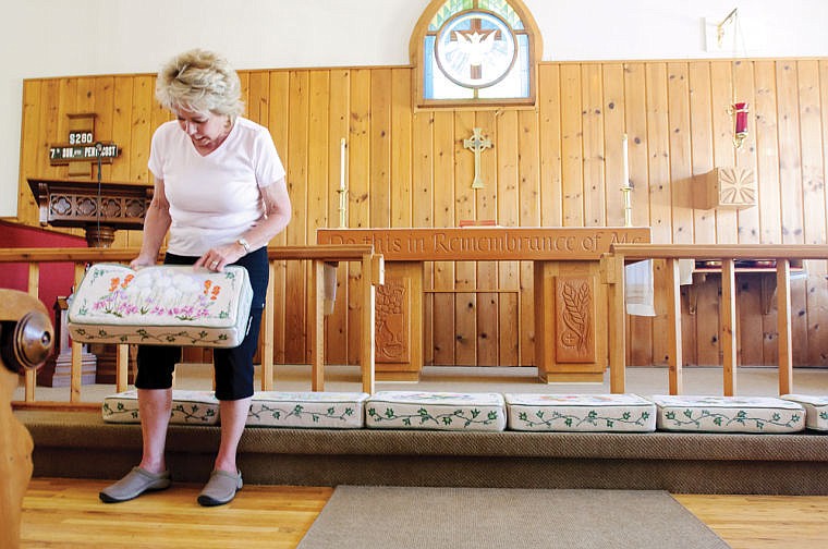 &lt;p&gt;Patty Saville holds up one of 12 needlepoint kneelers Monday afternoon at St. Patrick's Episcopal Church in Ferndale. A group of stitchers have been working on the kneeling pads for two and a half years. July 1, 2013 in Ferndale, Montana. (Patrick Cote/Daily Inter Lake)&lt;/p&gt;