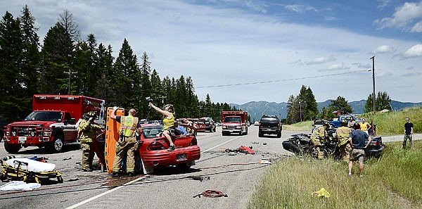 &lt;p&gt;&lt;strong&gt;AN EMERGENCY RESPONDER&lt;/strong&gt; holds an intravenous line while others work to move one of the victims of a head-on collision on U.S. 93 two miles south of Whitefish shortly after 1 p.m. Friday. At right, other responders attend to a victim in the other vehicle. Three people were injured in the collision, two of them apparently suffering serious injuries. At least one victim had to be extricated from his vehicle with the use of the Jaws of Life. The Whitefish and Kalispell fire departments responded to the accident, which shut down all but one lane of the highway for more than an hour. They were joined by members of the Flathead County Sheriff&#146;s Office and the Montana Highway Patrol. (Brenda Ahearn/Daily Inter Lake)&lt;/p&gt;&lt;p&gt;&lt;/p&gt;