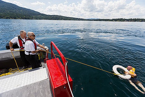 &lt;p&gt;Mike Mather, far left, and Brad Van Ert, division chiefs with Northern Lakes, pull Press reporter Jeff Selle safely back to the boat after throwing out a life preserver during a man-overboard exercise.&lt;/p&gt;