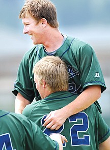 Tyler Linse is lifted off the ground by Matt Detwiler as they celebrate their win over Anacortes on Saturday in Kalispell.