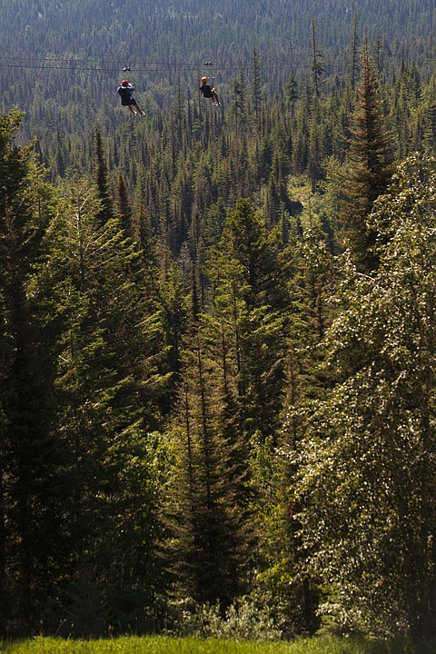<p>Jacob, left, and Alison Szulewski soar 300 feet over the ground on Whitefish Mountain Resort's tallest zip line. Wednesday, July 11, 2012 in Whitefish, Montana.</p>
