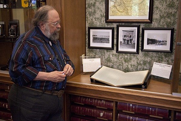 &lt;p&gt;Flathead County Museum president of the board Richard Hardesty looks at one of two displays full of Demersville documents in the County Courthouse Building in Kalispell on Thursday, July 12. The Don Kaltschmidt family loaned the historical documents to the museum.&lt;/p&gt;