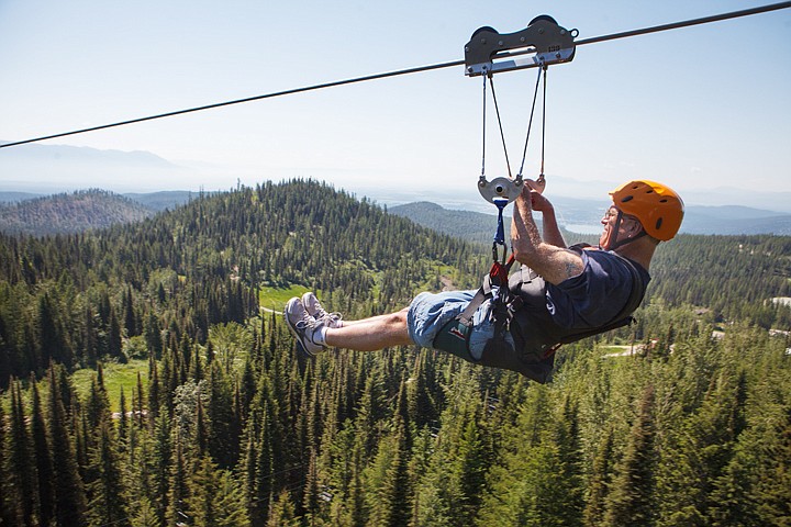 &lt;p&gt;Kelly Carberry of Stevensville takes in views of the Flathead Valley and Bad Rock Canyon as he rides down the new 1,900-foot zip line at Whitefish Mountain Resort on Wednesday morning. Wednesday, July 11, 2012 in Whitefish, Montana.&lt;/p&gt;